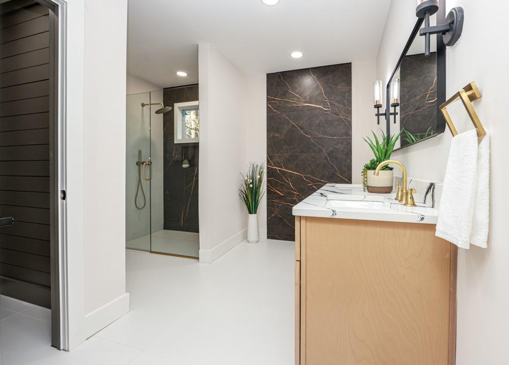2566 Creekwood Terrace Decatur, GA 30030 - Photo 24 of 49 a bathroom with a granite countertop sink a mirror and shower