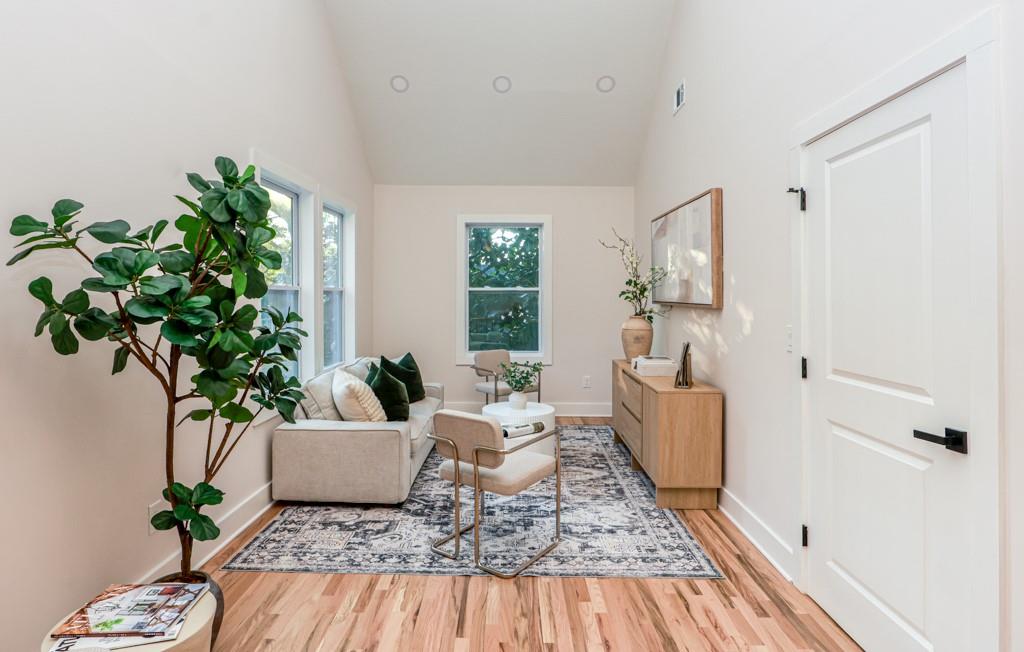 2566 Creekwood Terrace Decatur, GA 30030 - Photo 31 of 49 a living room with furniture floor to ceiling window and potted plant