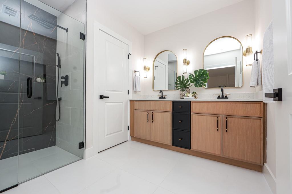 2566 Creekwood Terrace Decatur, GA 30030 - Photo 36 of 49 a spacious bathroom with a double vanity sink a mirror and shower