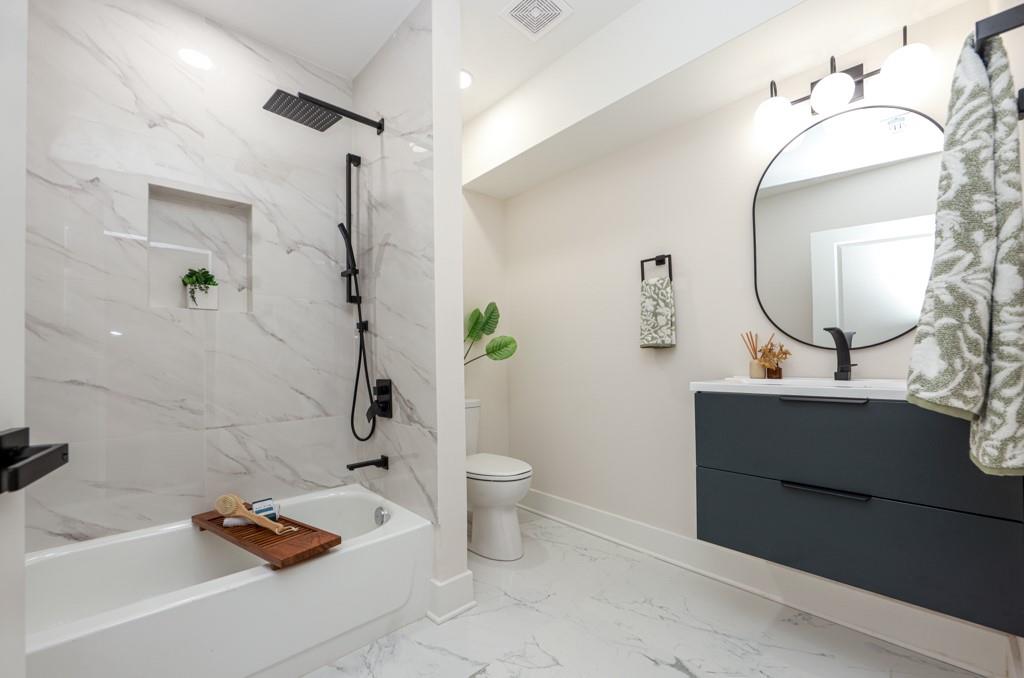 2566 Creekwood Terrace Decatur, GA 30030 - Photo 42 of 49 a bathroom with a sink a toilet and shower