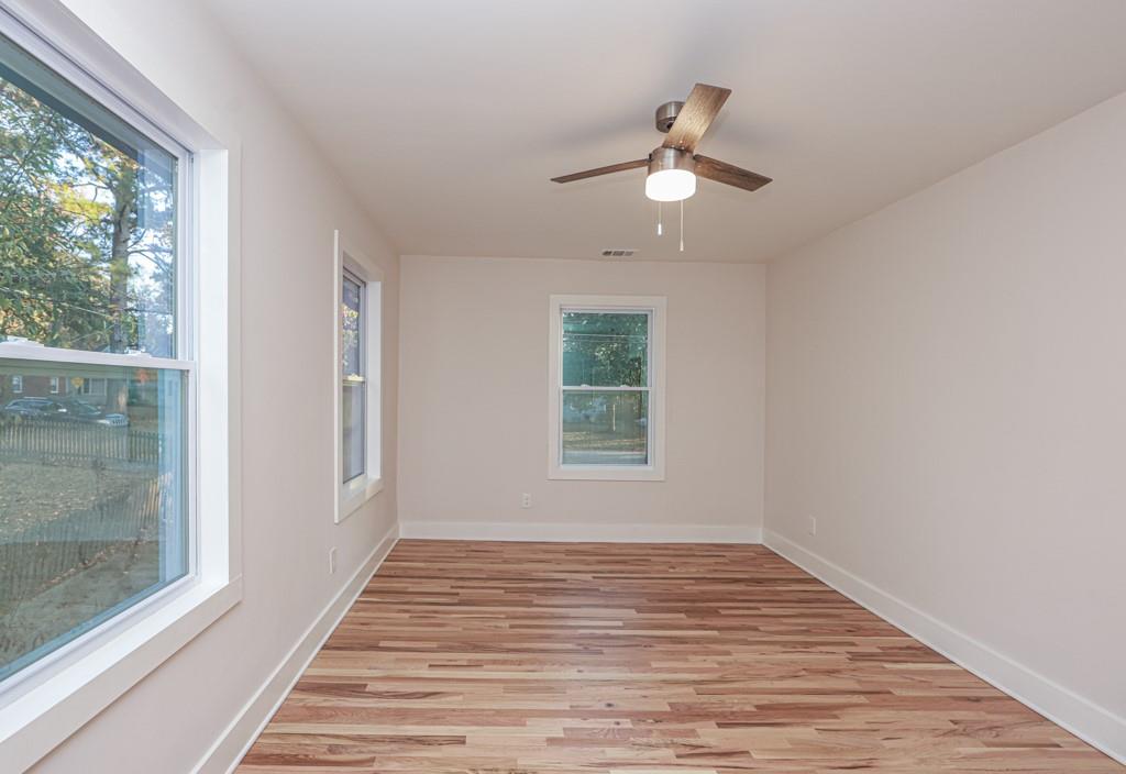 2566 Creekwood Terrace Decatur, GA 30030 - Photo 45 of 49 an empty room with wooden floor fan and windows