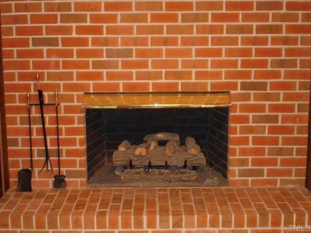 3919 Hope Valley Road Durham, NC 27707 - Photo 5 of 7 Brick hearth fireplace in family room as well as downstairs in 'rec room' in basement