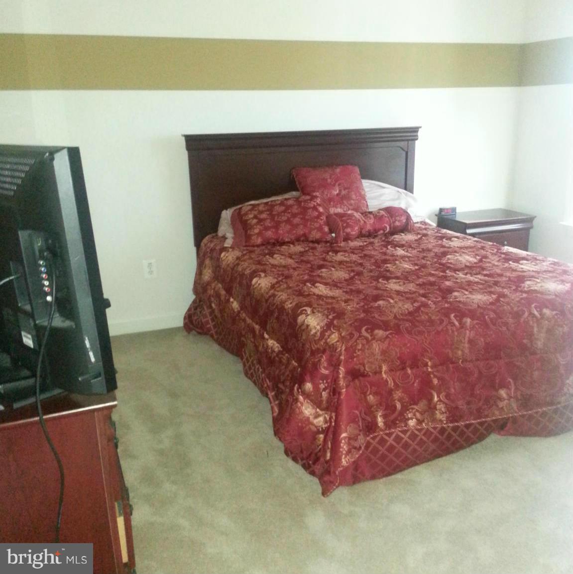 2000 Medinah Ridge Road Accokeek, MD 20607 - Photo 16 of 20 a bed sitting in a room next to a window