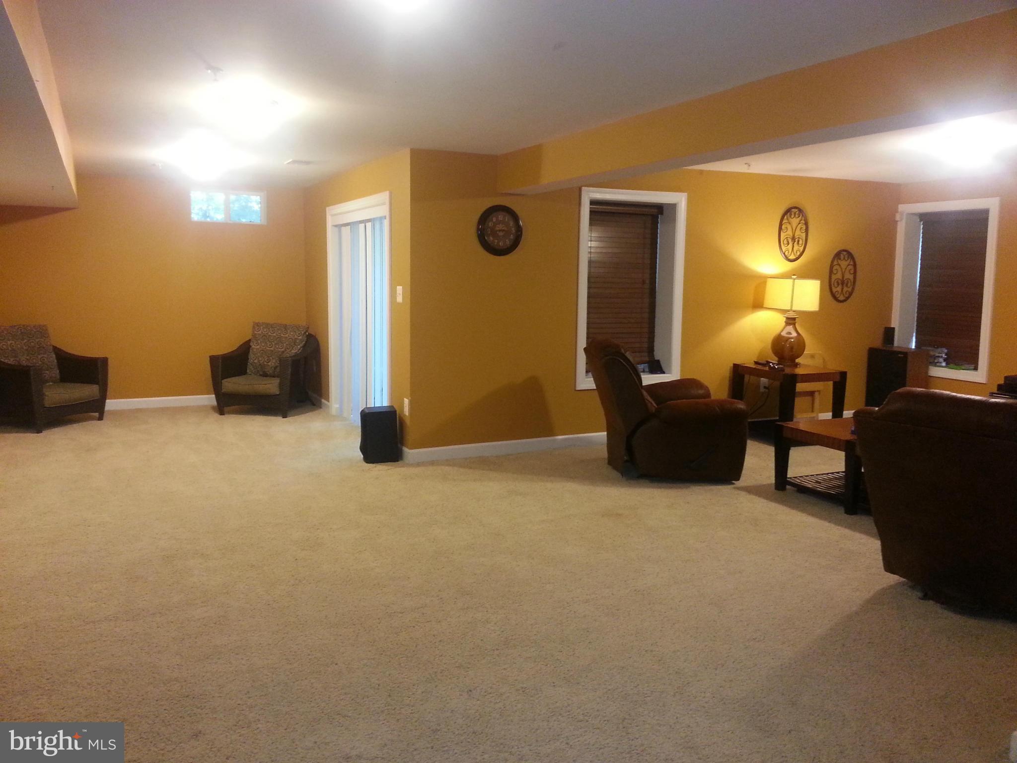 2000 Medinah Ridge Road Accokeek, MD 20607 - Photo 18 of 20 a living room with furniture and a lamp