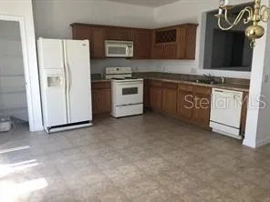 a kitchen with stainless steel appliances a stove a sink and a refrigerator