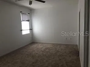 an empty room with windows and closet