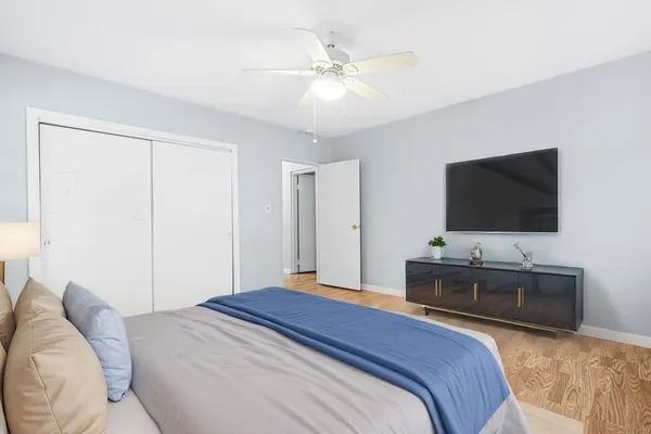 a bedroom with a bed a couch and dresser