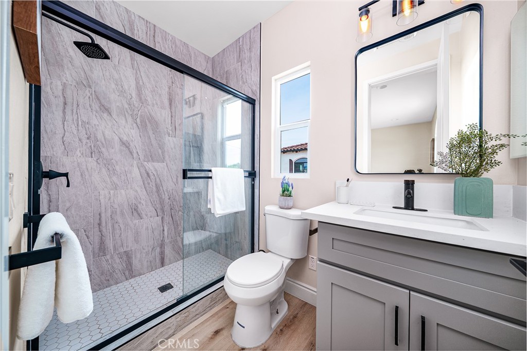 2709 Cogswell Road, Unit A El Monte, CA 91732 - Photo 15 of 57 a bathroom with a granite countertop sink toilet a mirror and shower
