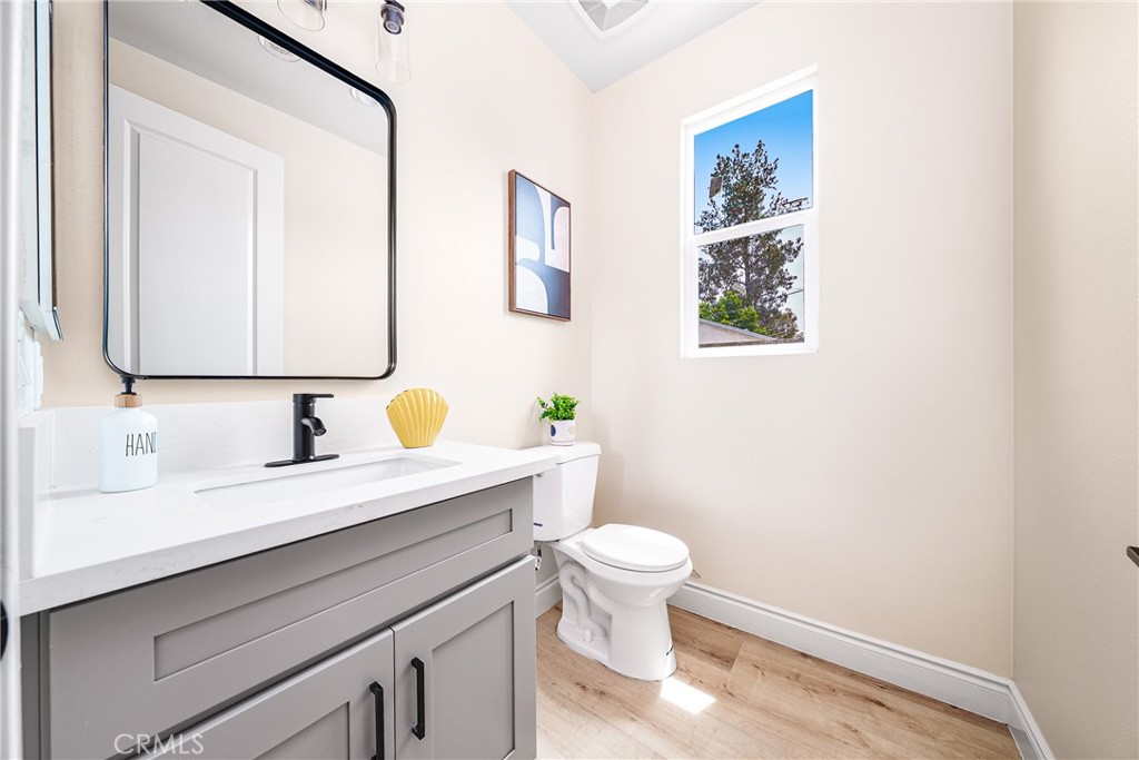2709 Cogswell Road, Unit A El Monte, CA 91732 - Photo 6 of 57 a bathroom with a granite countertop toilet sink and mirror