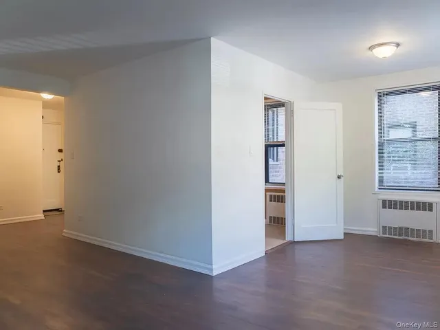 an empty room with closet and windows