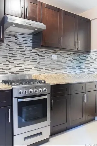 a kitchen with granite countertop cabinets stove and oven