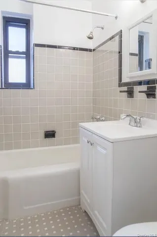 a bathroom with a sink a toilet a vanity and bathtub