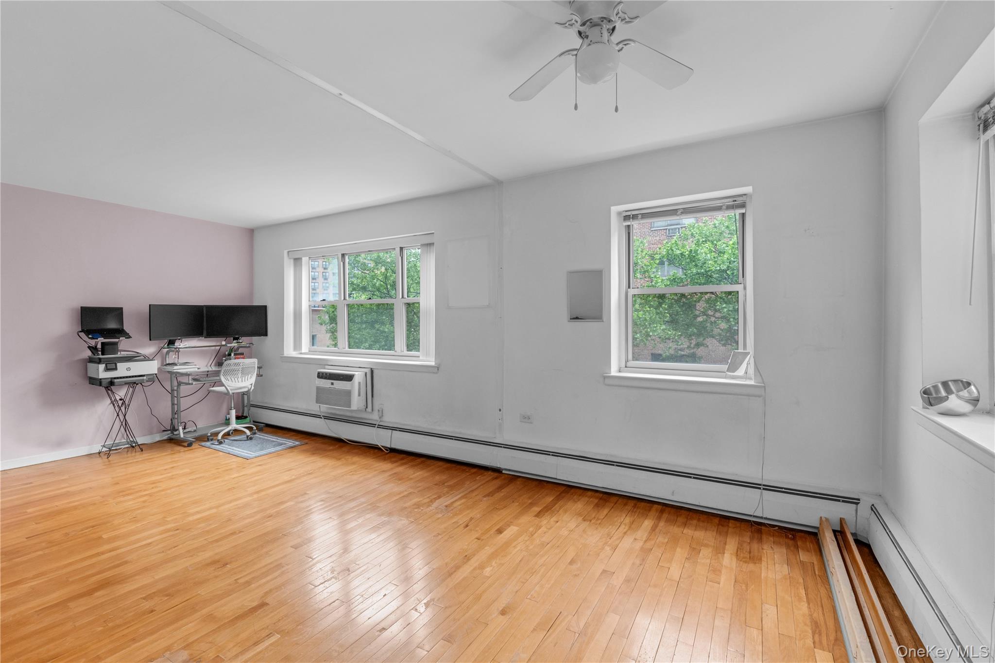 99-10 60th Avenue, Unit 3B Queens, NY 11368 - Photo 9 of 27 a living room with furniture and a window