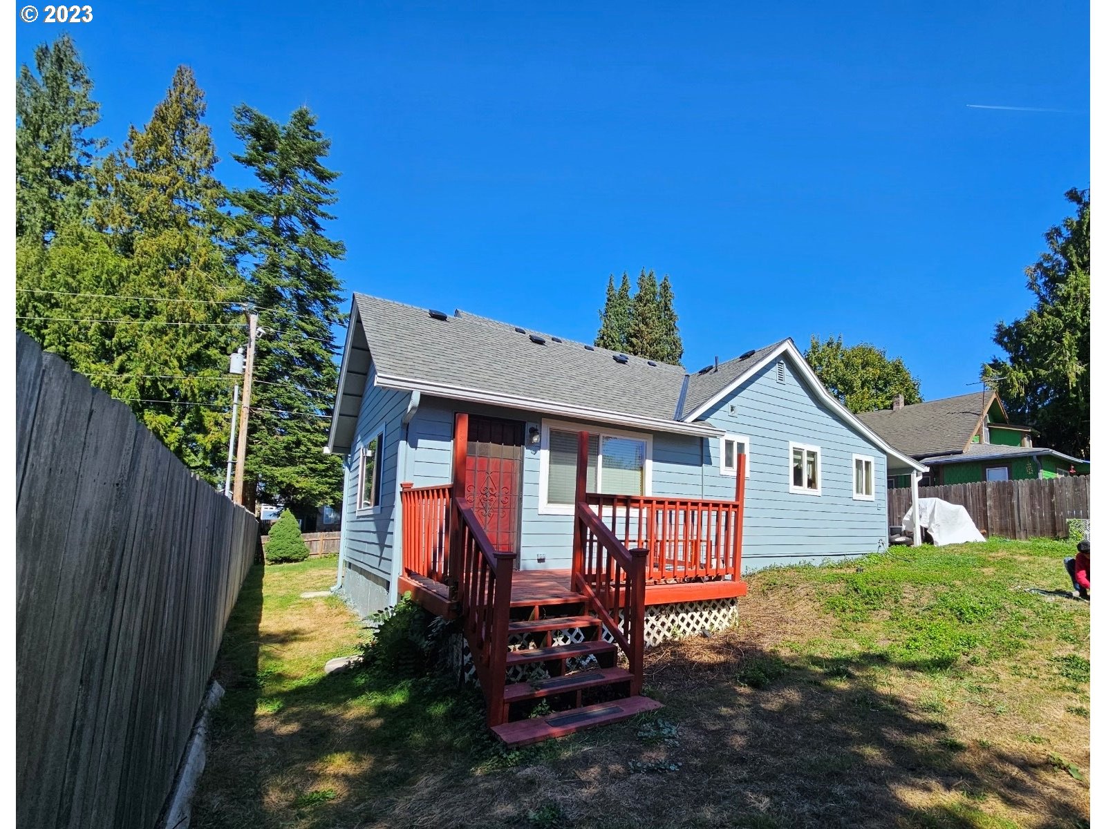7 Elm Street Ridgefield, WA 98642 - Photo 1 of 2 a view of a house with a small yard and wooden fence