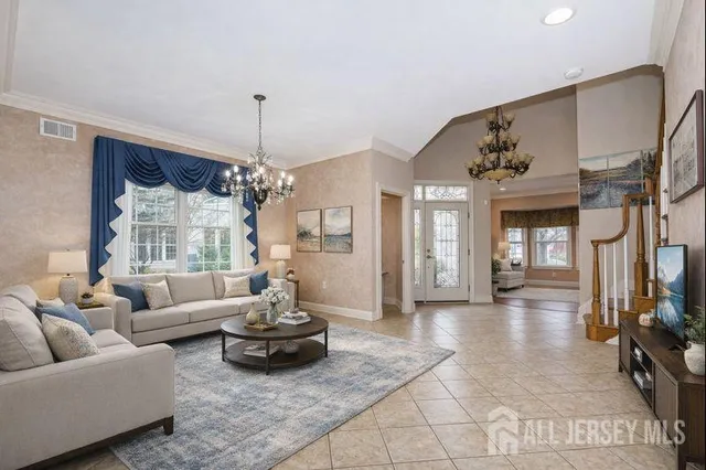 a view of a dining room with furniture and chandelier
