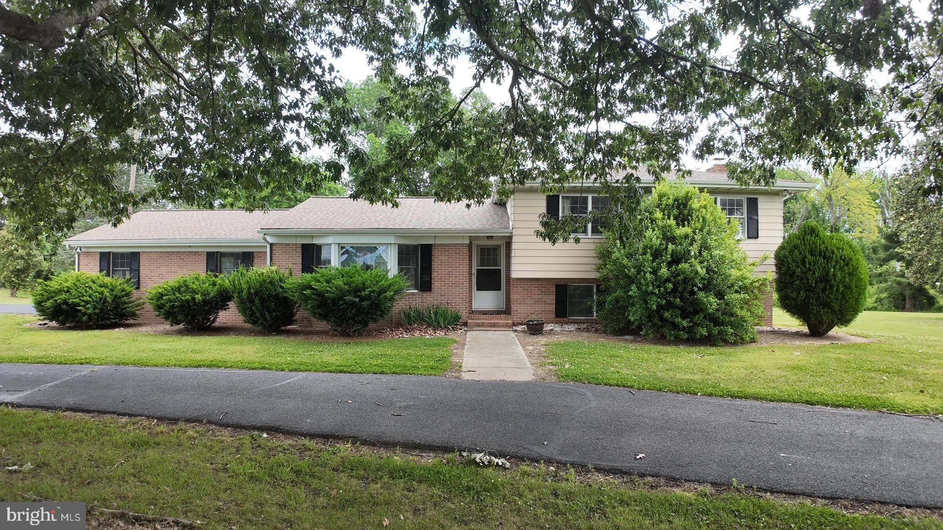 8936 Goldsborough Neck Road Easton, MD 21601 - Photo 2 of 13 a front view of a house with a yard and garage