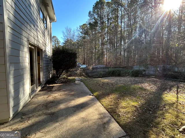 a view of backyard with wheel chair and potted plants