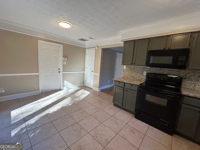 a kitchen with stainless steel appliances granite countertop a stove and a refrigerator