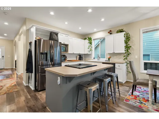 a kitchen that has a lot of cabinets a sink and a refrigerator