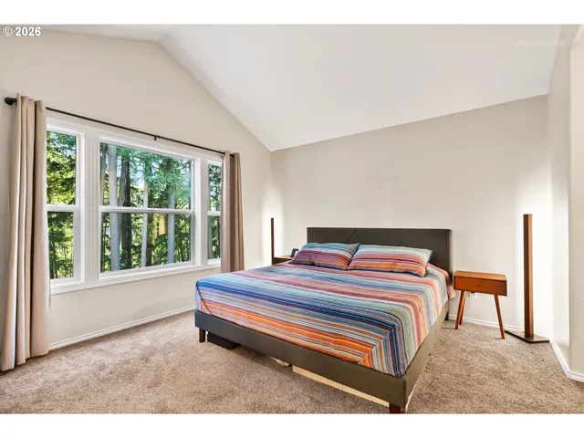 a bedroom with a bed and a large window