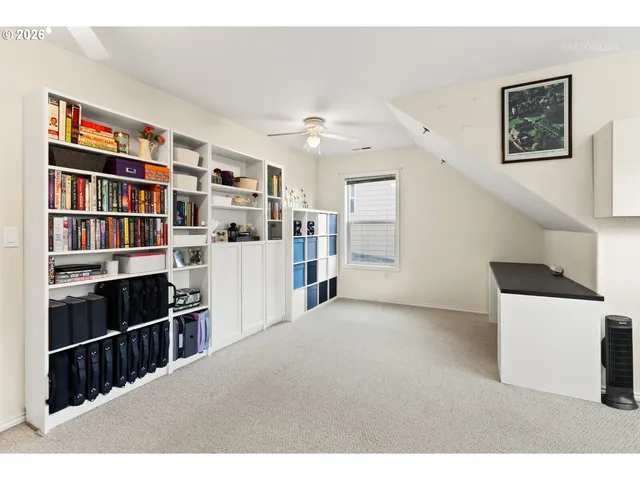 a view of a livingroom with workspace and a window