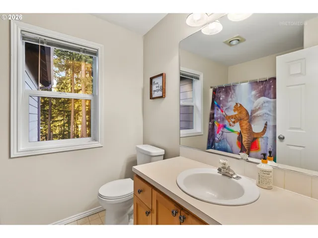 a kitchen with a sink a counter top space and a refrigerator