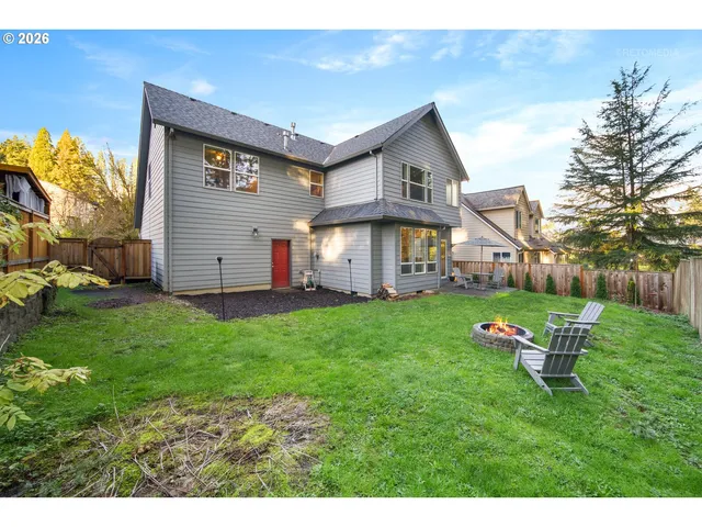 an aerial view of a house with a yard basket ball court and outdoor seating
