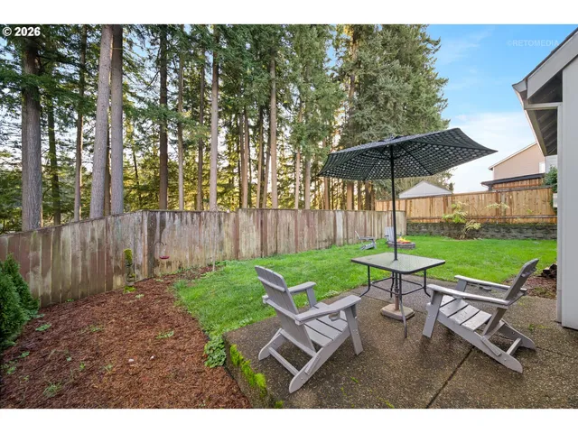 a view of a table and chairs under an umbrella