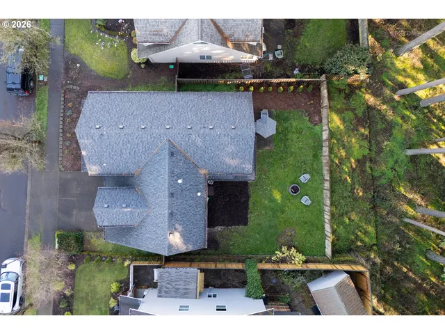 an aerial view of a house with garden space and street view