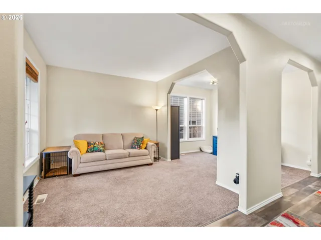 a living room with furniture and a table