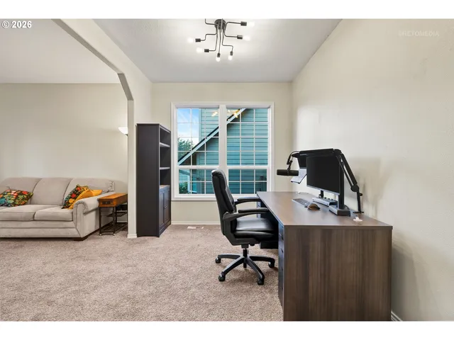 a work room with furniture and a window