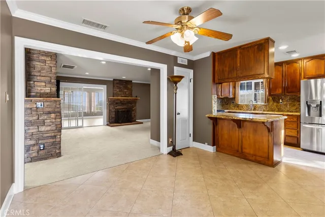 a view of a kitchen with a sink and a refrigerator