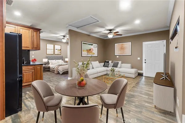 a living room with furniture a flat screen tv and a window