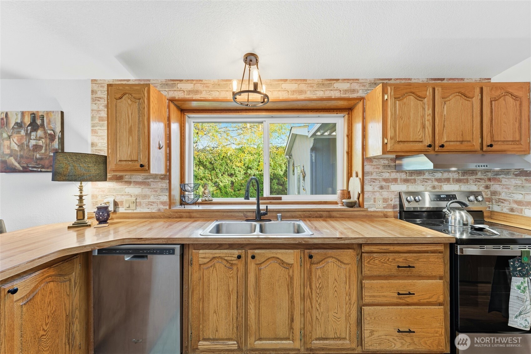 1352 Rancho Villa Walla Walla, WA 99362 - Photo 15 of 35 a kitchen with granite countertop a sink and a window