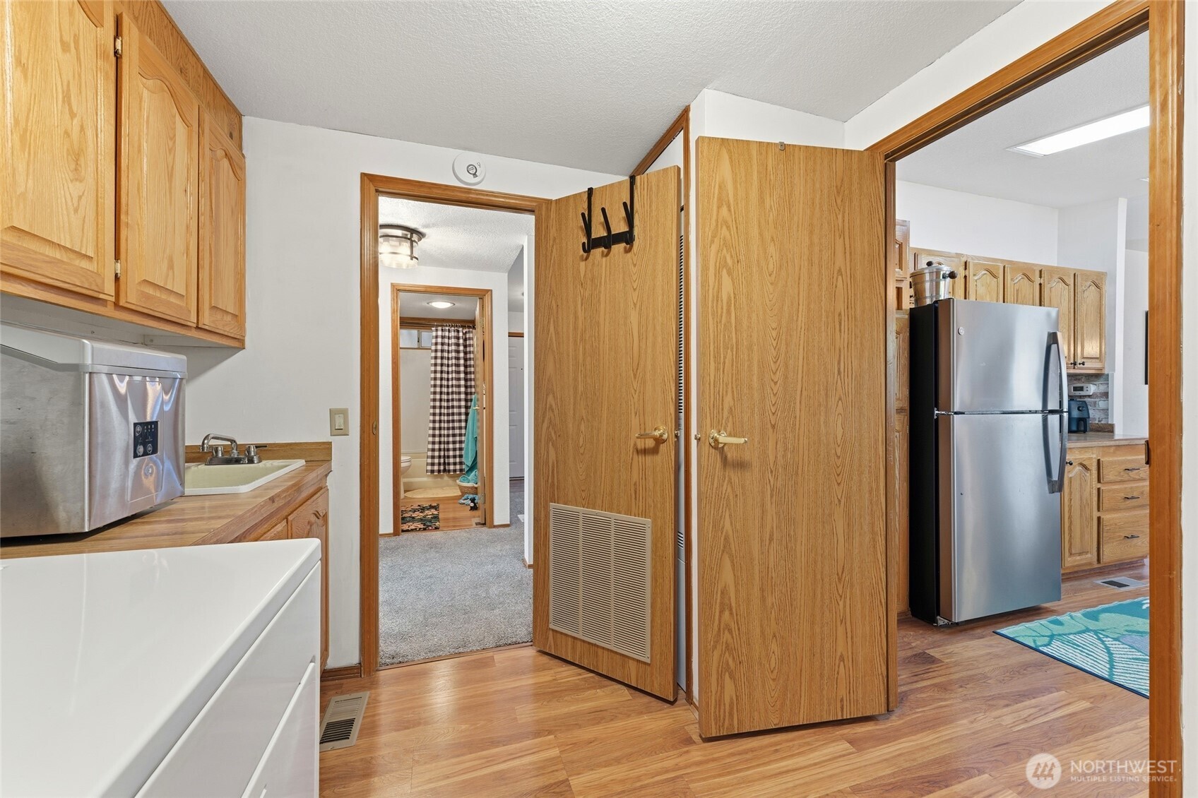 1352 Rancho Villa Walla Walla, WA 99362 - Photo 29 of 35 a view of a refrigerator in kitchen and wooden floor
