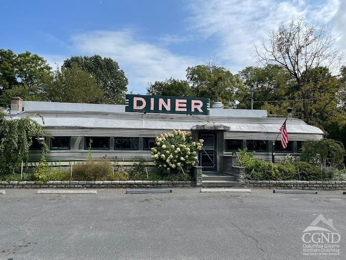 7550 North Broadway Red Hook, NY 12571 - Photo 1 of 19 a front view of a house with a garden