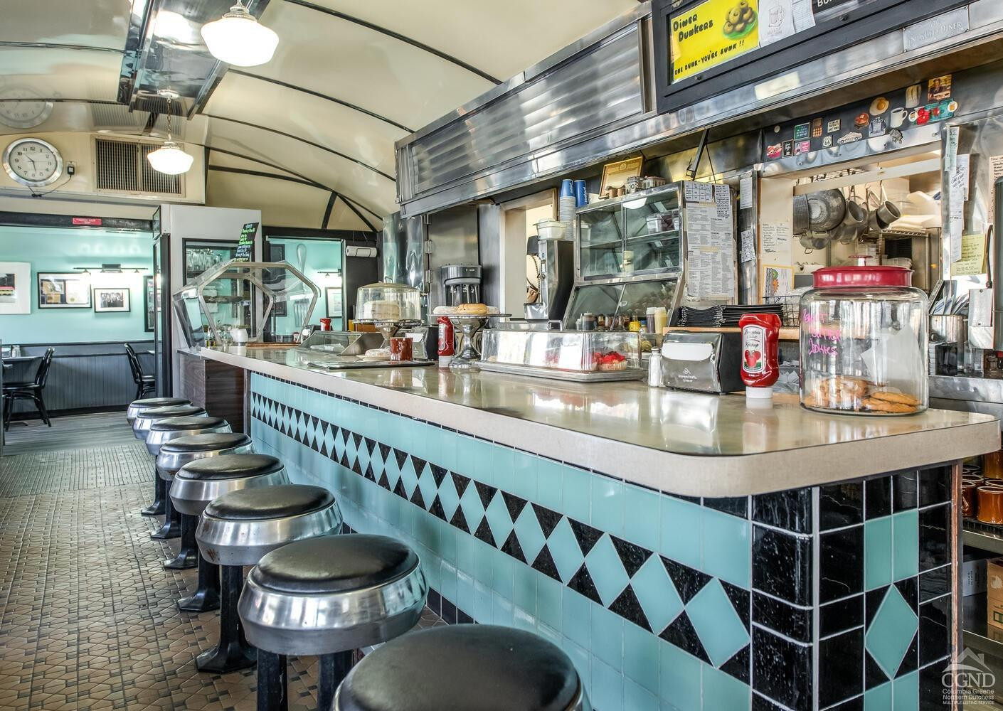 7550 North Broadway Red Hook, NY 12571 - Photo 3 of 19 a room with stainless steel appliances kitchen island granite countertop lots of wooden furniture and a large window