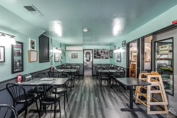 a view of a dining room with furniture and wooden floor