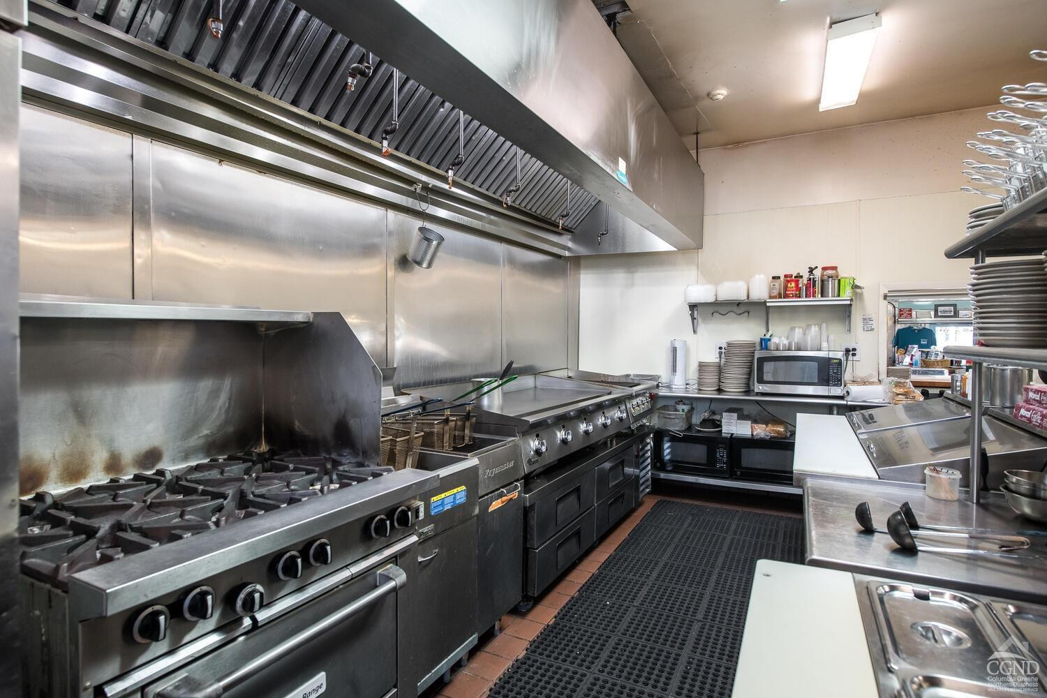 7550 North Broadway Red Hook, NY 12571 - Photo 9 of 19 a kitchen with a stove and a wooden floors