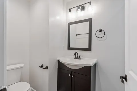 a bathroom with a toilet a sink and mirror