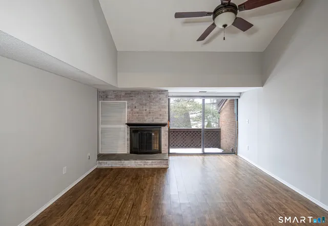 a view of wooden floor a sink and a fireplace in a room