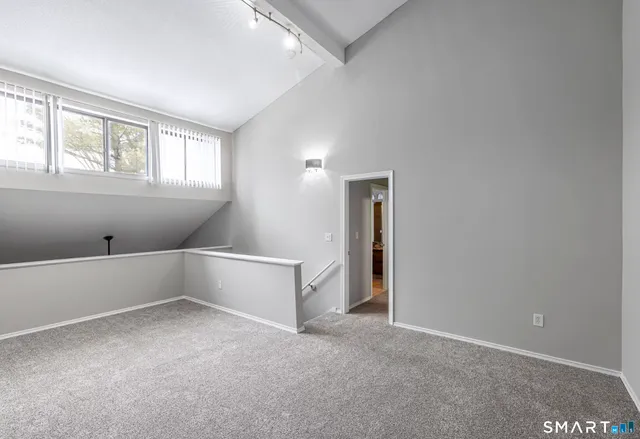 an empty room with windows and cabinet