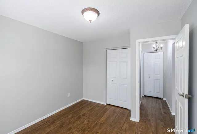 a view of a room with wooden floor