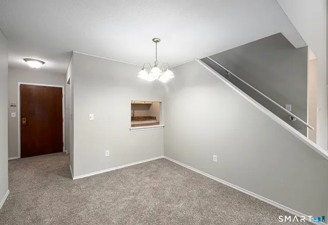 a view of a hallway with a chandelier