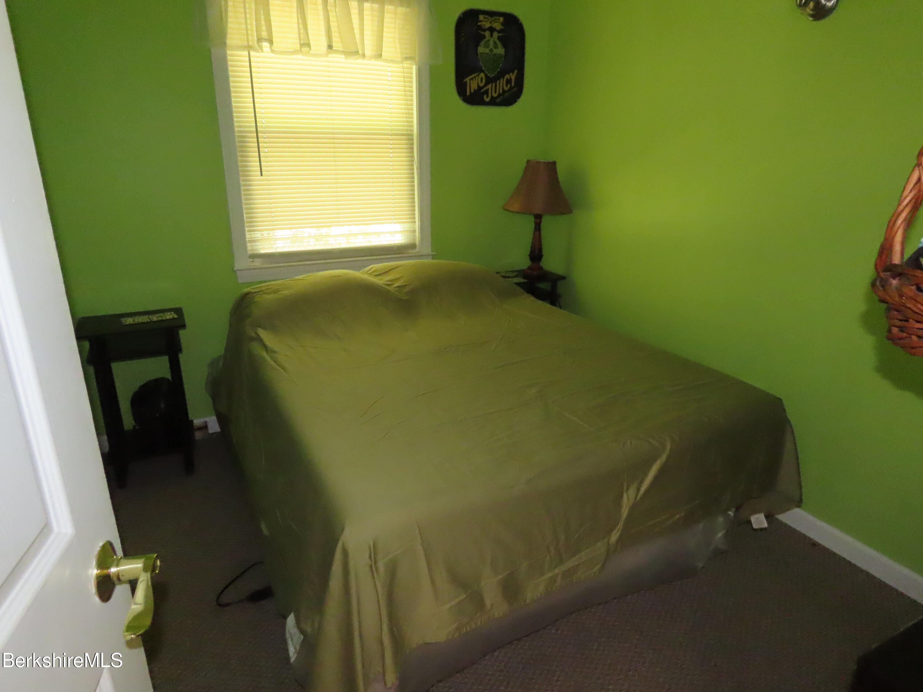 250 Magee Road Stamford, VT 05352 - Photo 18 of 35 a bed sitting in a bedroom next to a window