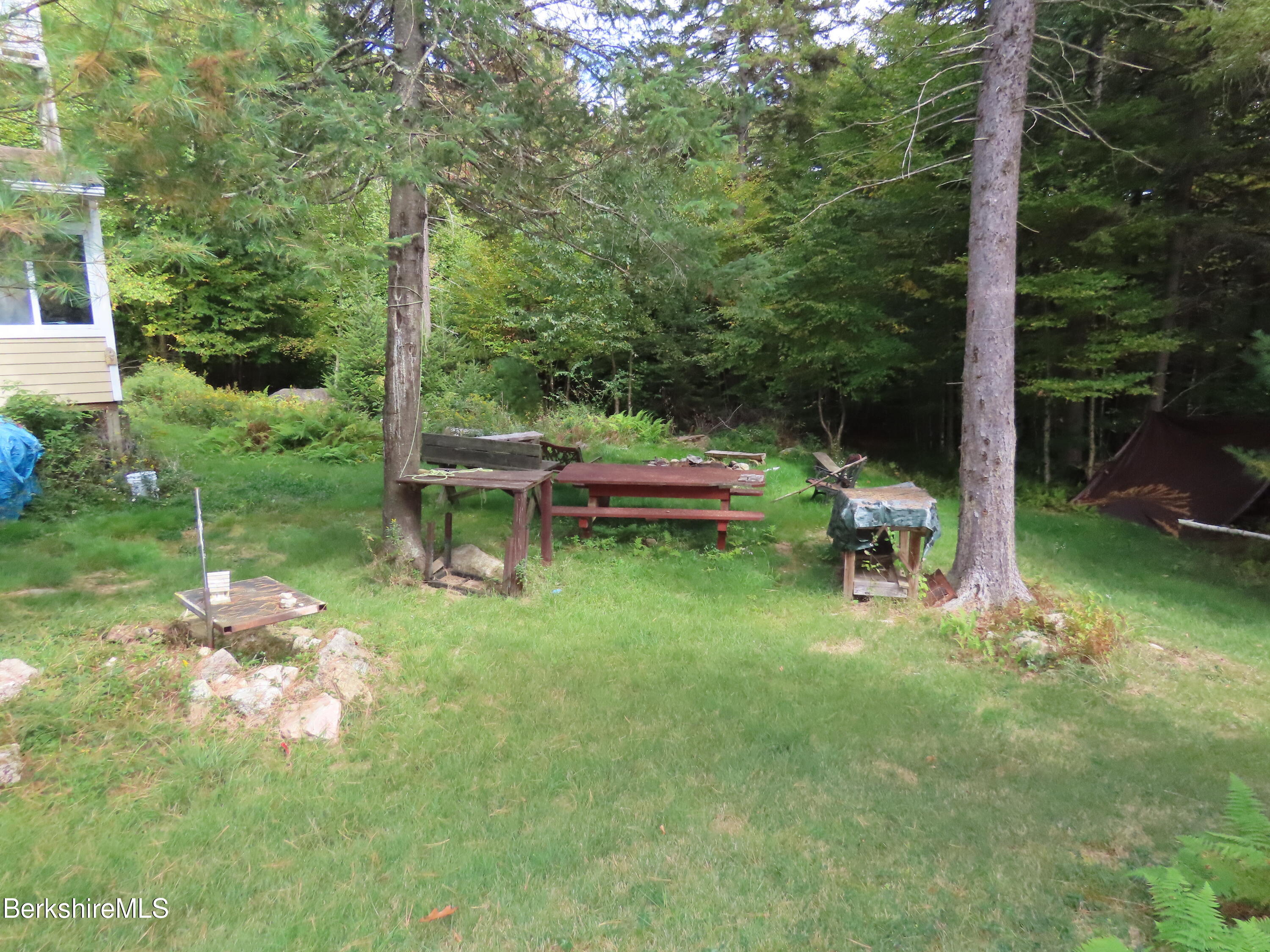250 Magee Road Stamford, VT 05352 - Photo 24 of 35 a backyard of a house with outdoor seating