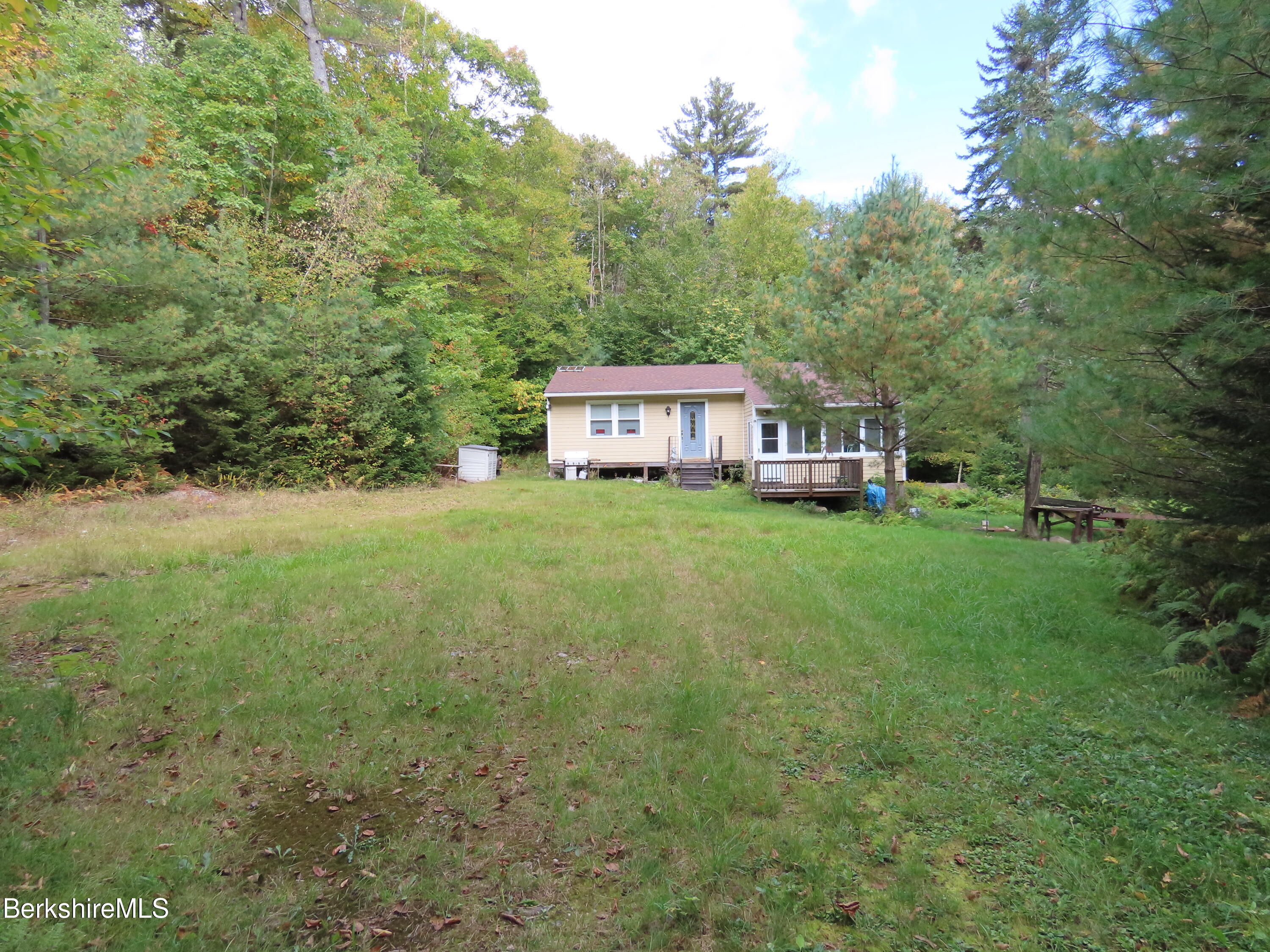 250 Magee Road Stamford, VT 05352 - Photo 31 of 35 a view of a house with a big yard and large trees