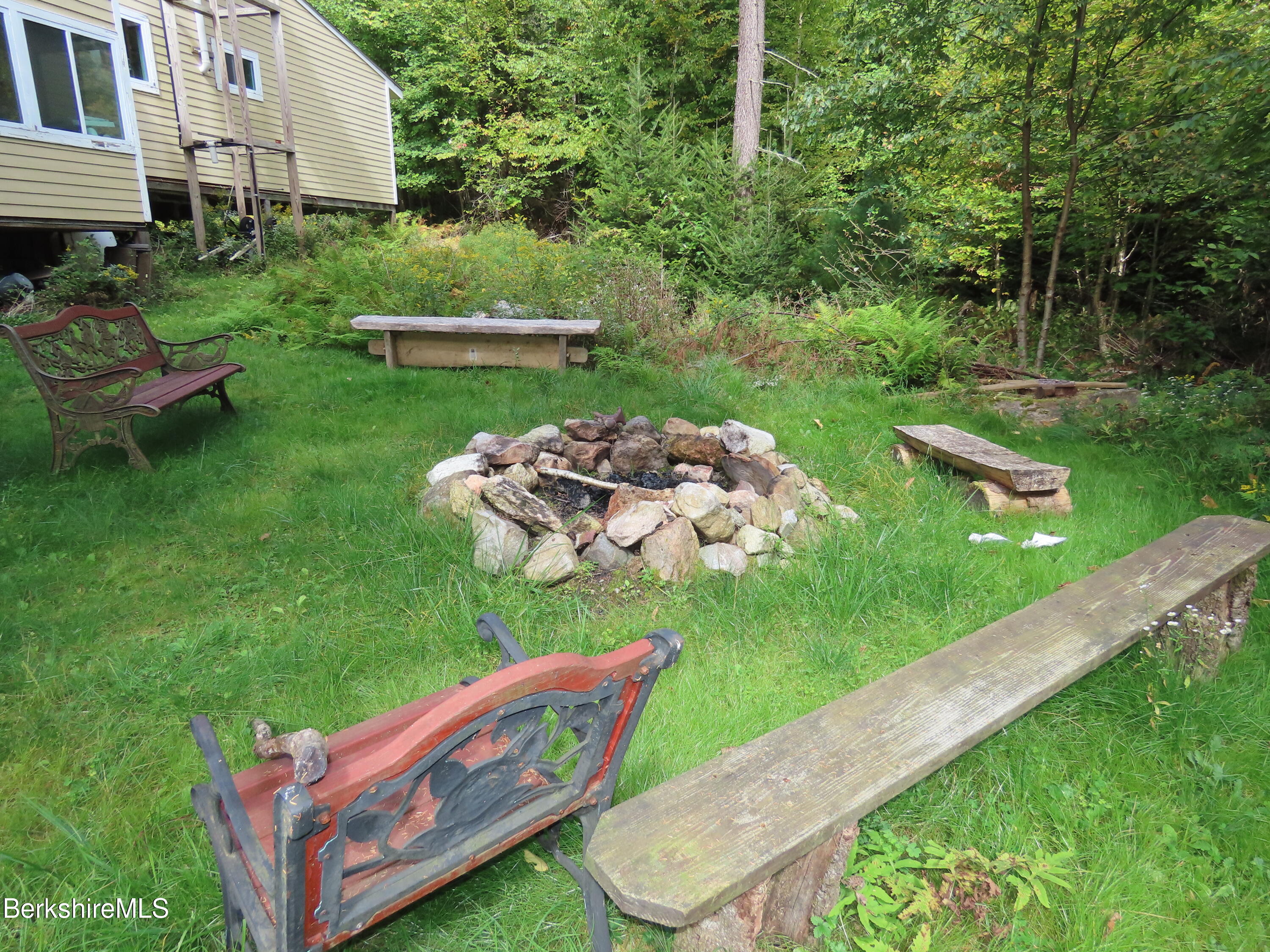 250 Magee Road Stamford, VT 05352 - Photo 5 of 35 a backyard of a house with table and chairs