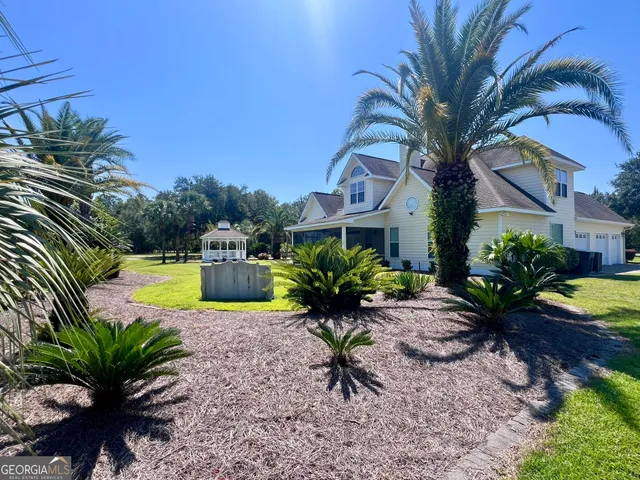 a view of a house with a swimming pool and sitting area