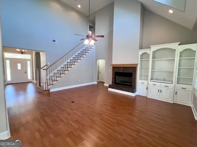 wooden floor in an empty room with a fireplace